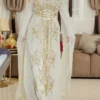 Elegant Beige Moroccan wedding kaftan with intricate gold embroidery, long sleeves, and a flowing cape, designed for brides and special occasions. A perfect blend of tradition and modern luxury (5)