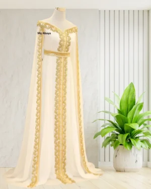white Moroccan bridal kaftan with gold embroidery, featuring an off-shoulder design and cape sleeves, perfect for weddings (1)